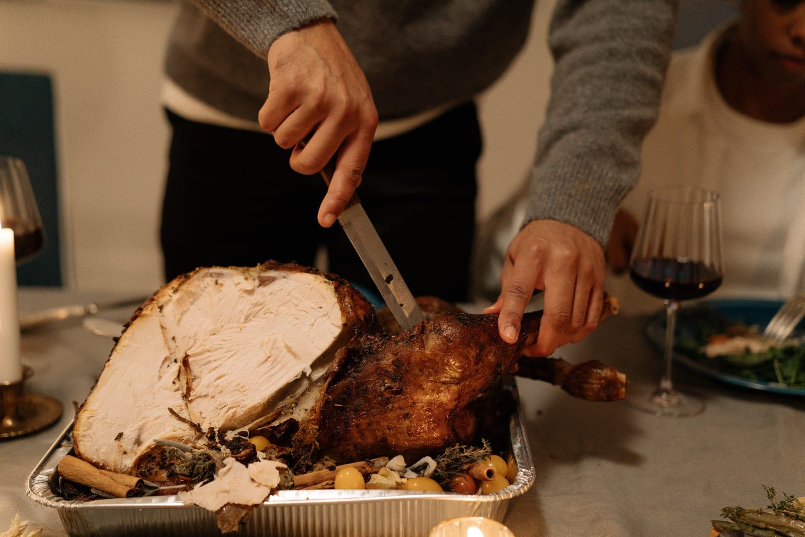 A roast turkey being carved with a carving knife