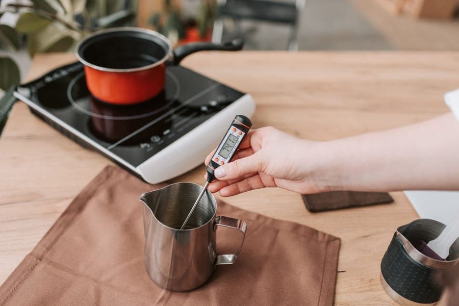 A digital kitchen thermometer being used